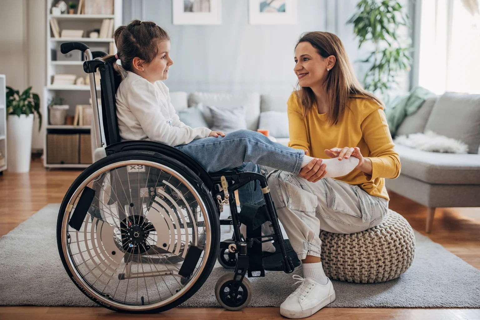 Compassionate NDIS support worker assisting a smiling participant with daily living activities in Caboolture, Queensland