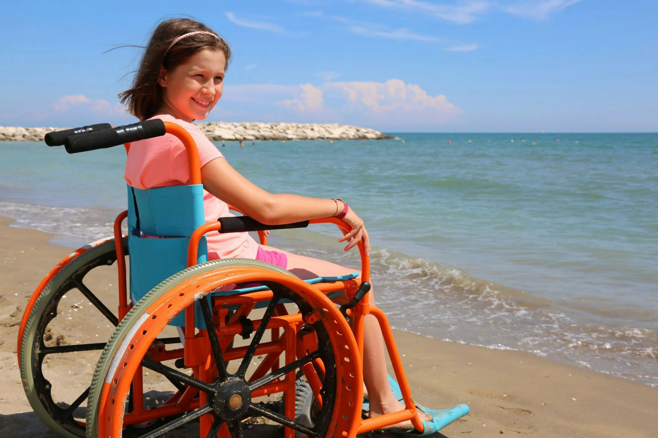 Accessible Gold Coast beach with mobility matting for wheelchair users enjoying the sunshine