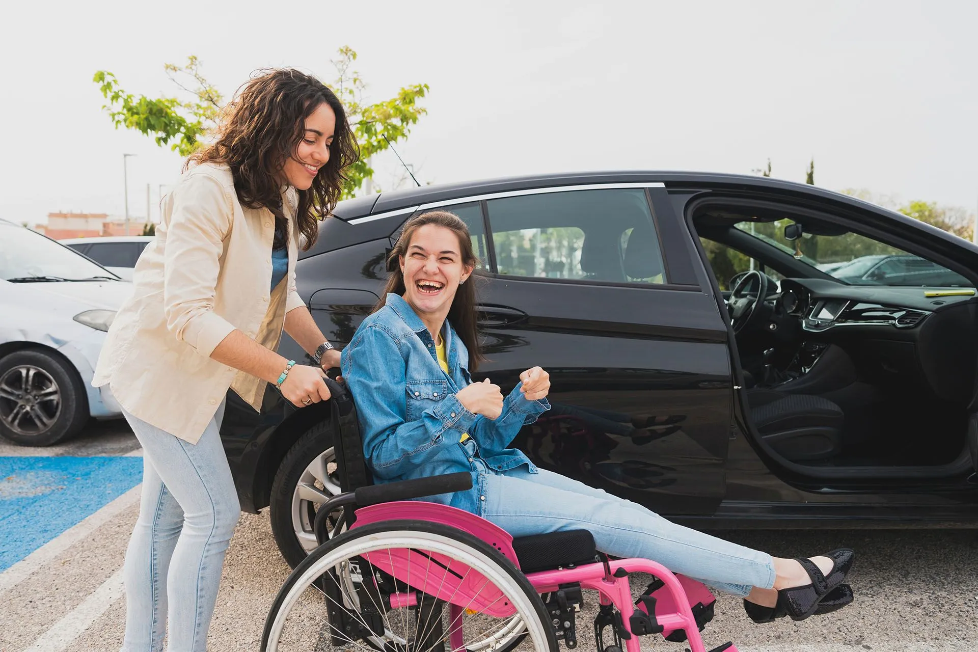 Support worker assisting an NDIS participant with daily household tasks in a living room