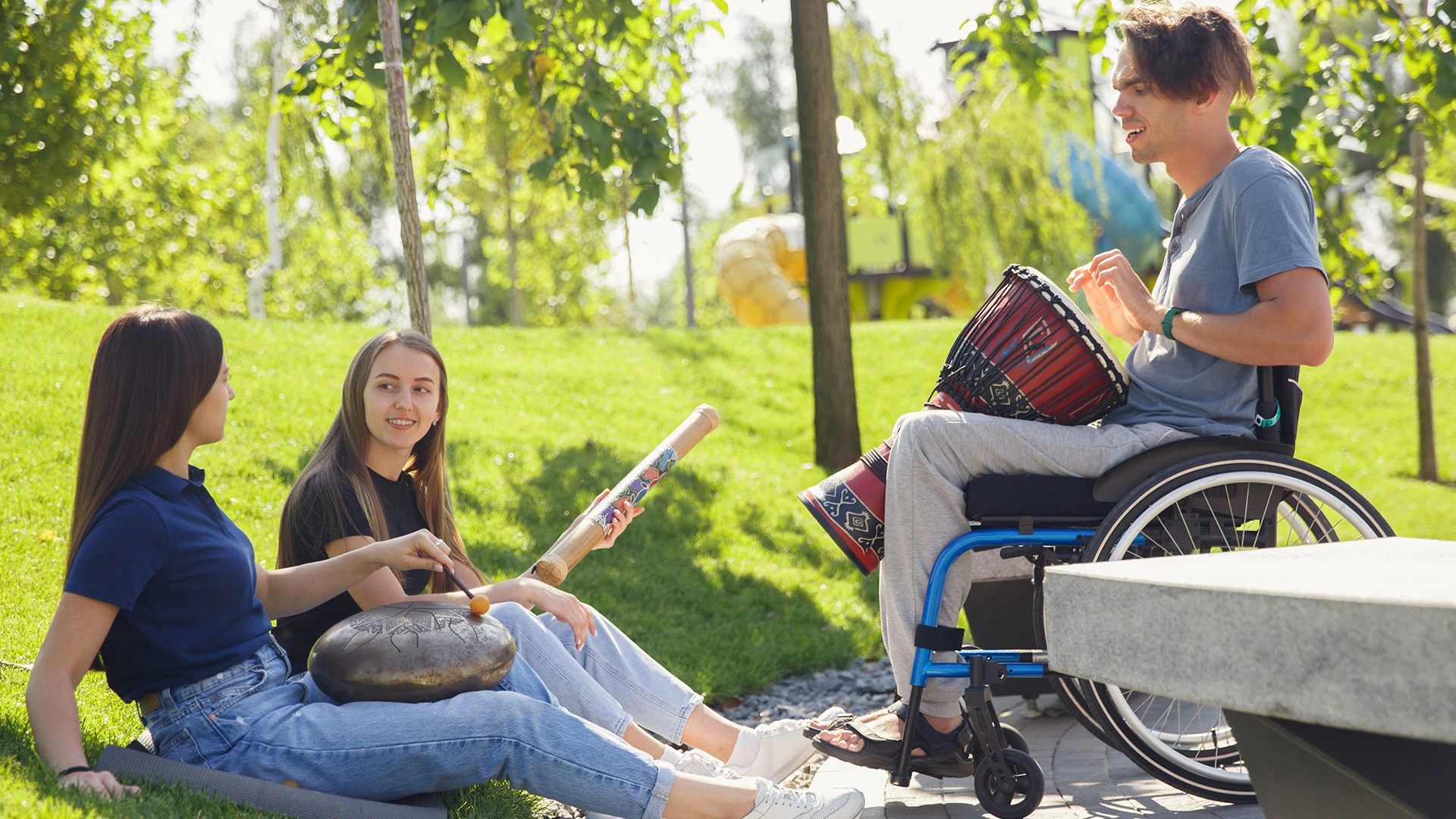 NDIS participant enjoying an accessible outdoor activity in a local park with support worker assistance
